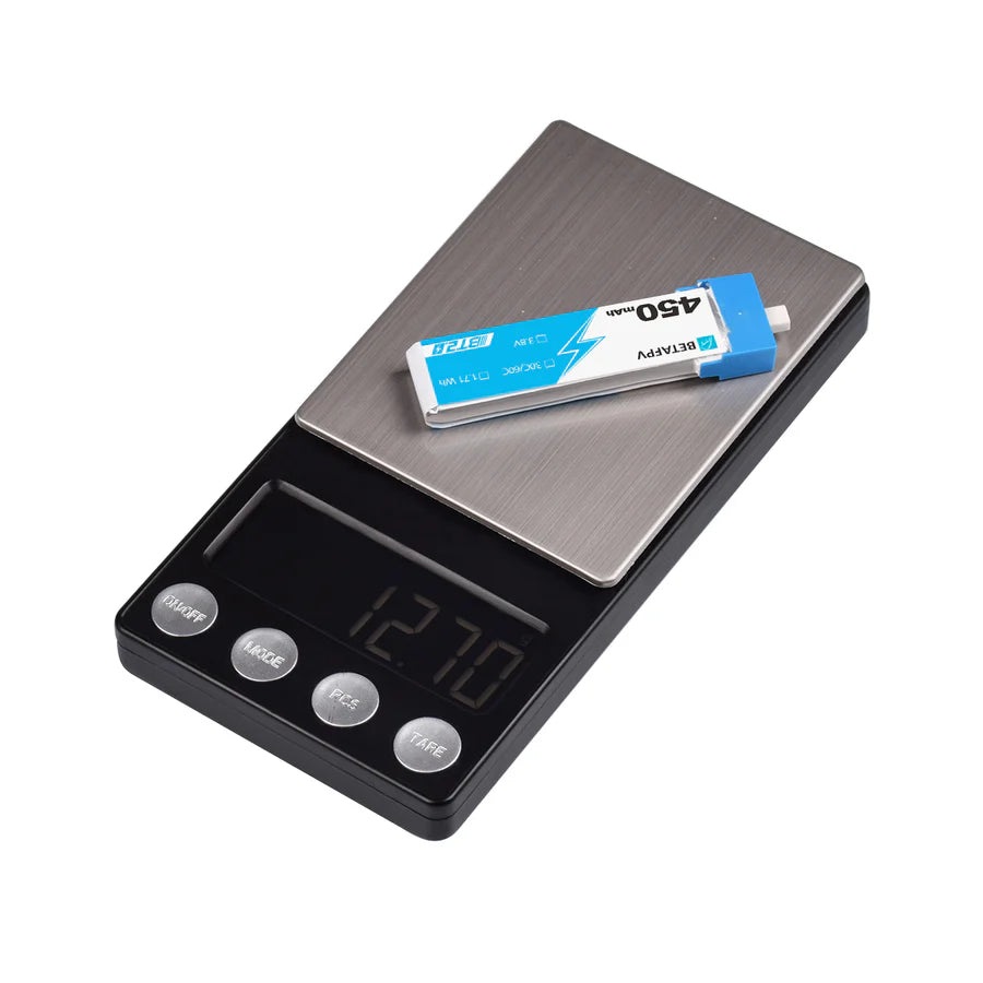 Digital scale with a BETAFPV 1S battery on a white background